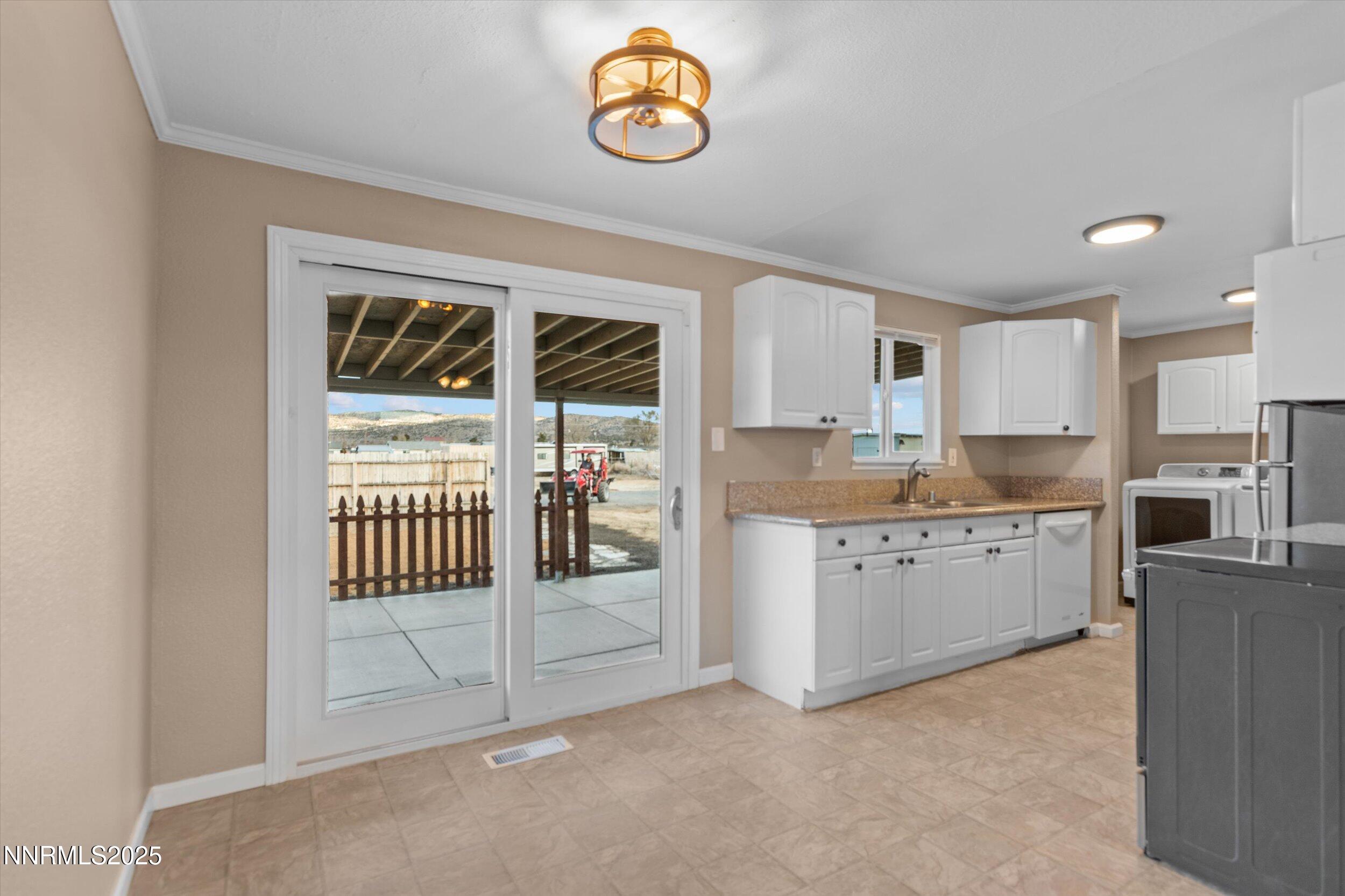 11567 Tupelo Street Reno, NV 89506 - Photo 6 of 32 a kitchen with granite countertop a stove a sink and a refrigerator