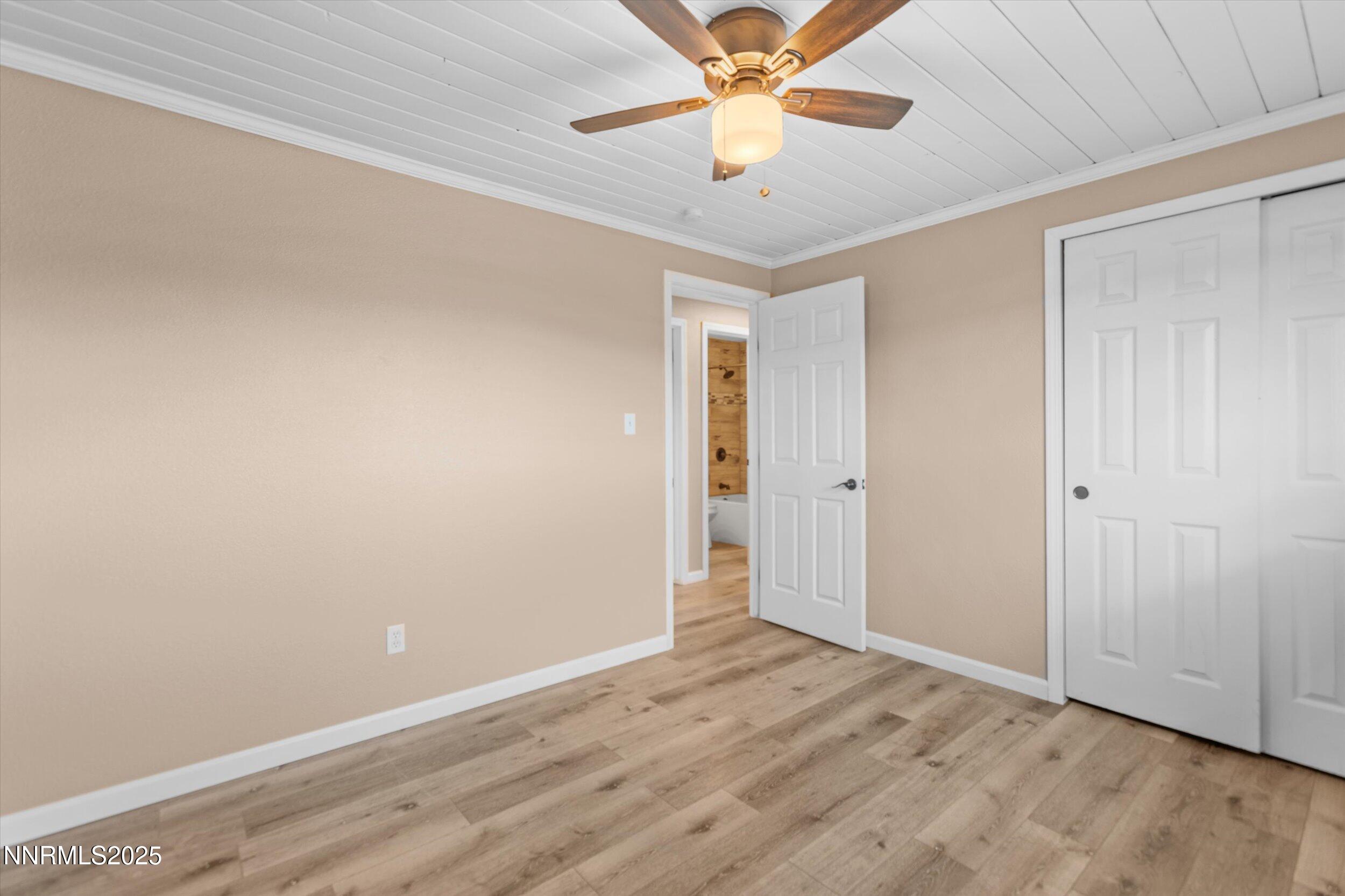 11567 Tupelo Street Reno, NV 89506 - Photo 10 of 32 an empty room with a ceiling fan and wooden floor