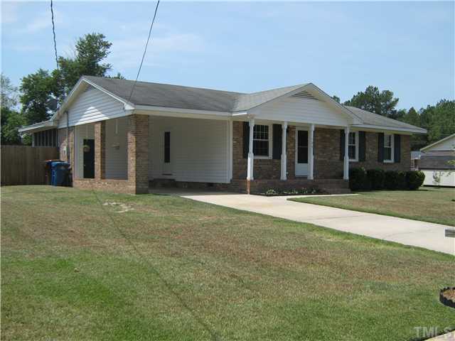 103 Poppy Street Dunn, NC 28334 - Photo 1 of 8 a front view of a house with a garden