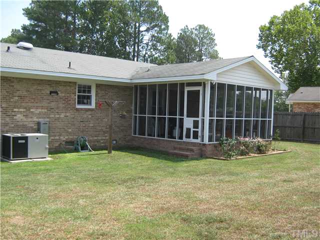 103 Poppy Street Dunn, NC 28334 - Photo 2 of 8 a view of a house with a yard and a large tree