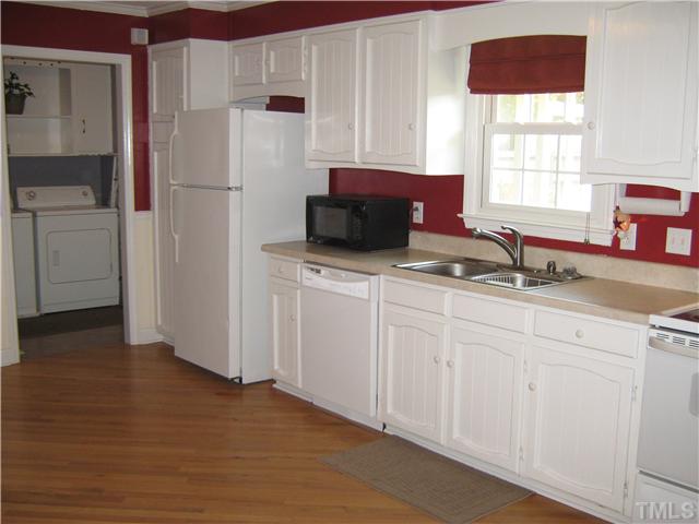 103 Poppy Street Dunn, NC 28334 - Photo 5 of 8 a kitchen with stainless steel appliances a sink a refrigerator and a window