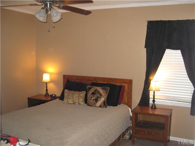 103 Poppy Street Dunn, NC 28334 - Photo 6 of 8 a bedroom with a bed and a window