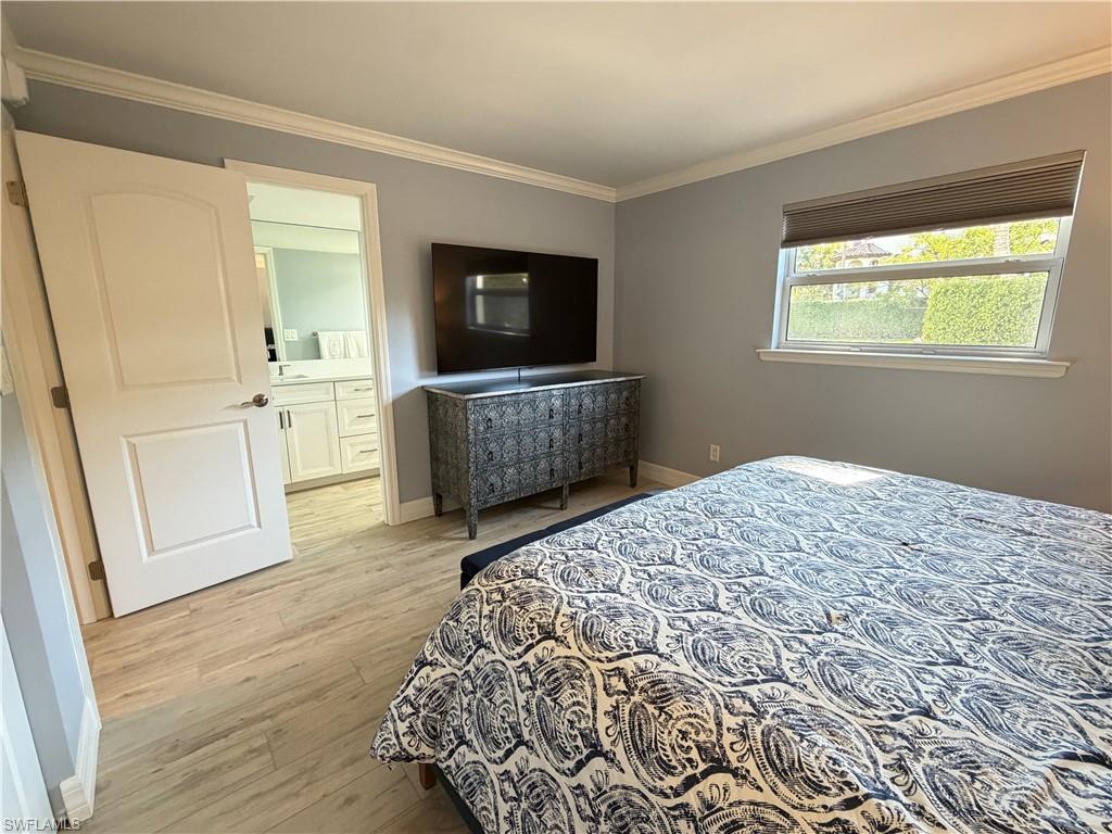 960 7th Street South, Unit 103 Naples, FL 34102 - Photo 15 of 16 a bedroom with a bed and a television