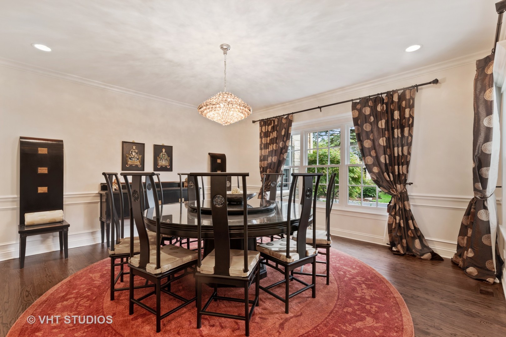 30 Meadowview Road Winnetka, IL 60093 - Photo 12 of 34 a view of a dining room and livingroom with furniture wooden floor a rug a flat screen tv and a chandelier