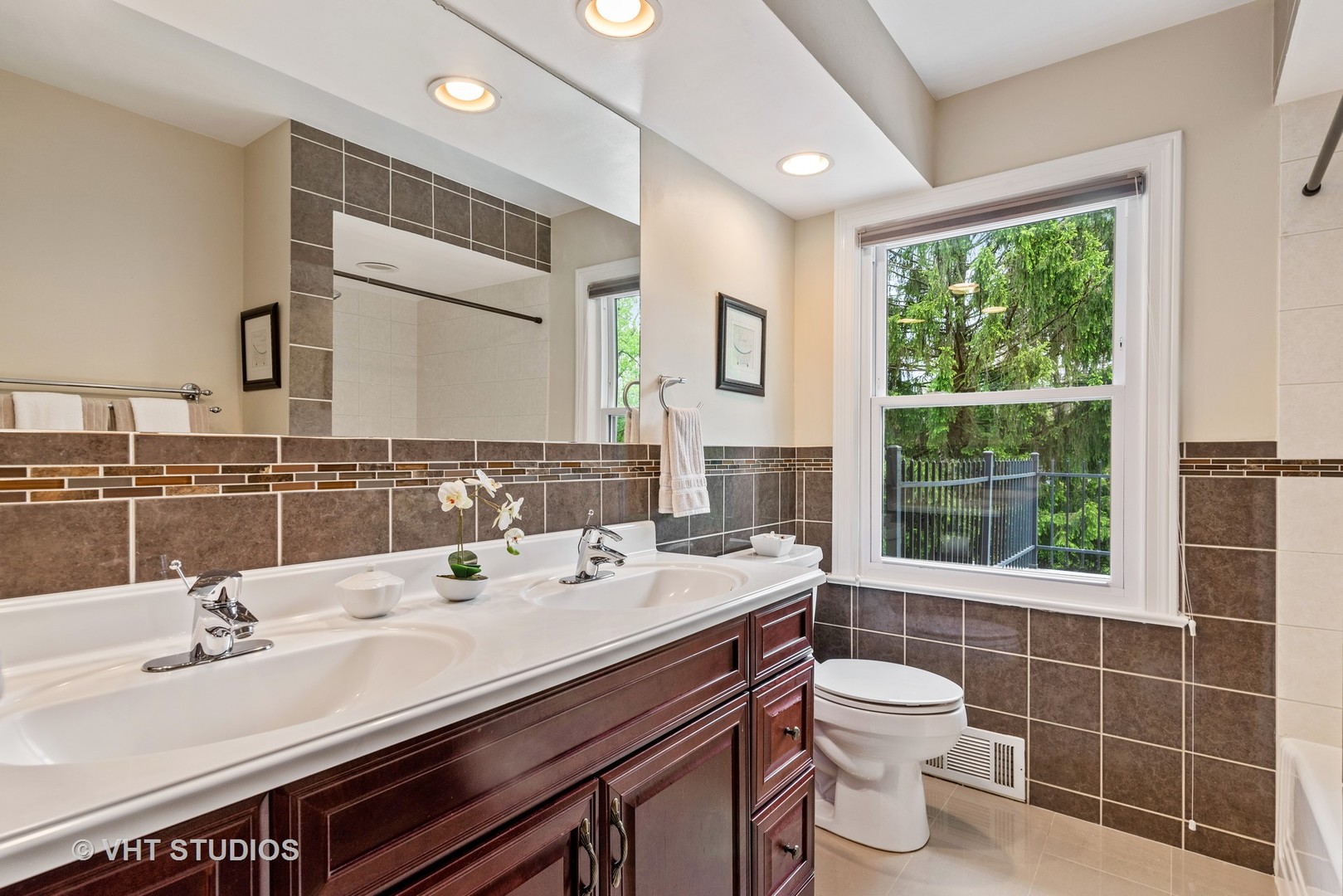 30 Meadowview Road Winnetka, IL 60093 - Photo 25 of 34 a bathroom with a double vanity sink toilet and a mirror
