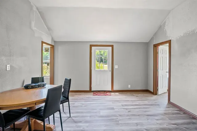 a view of a dining room with furniture and window