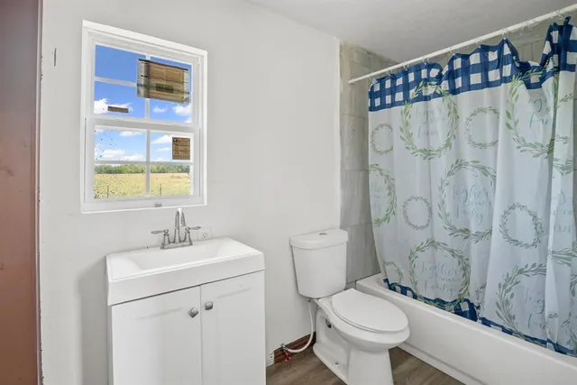 a very nice looking room with a window and wooden floor