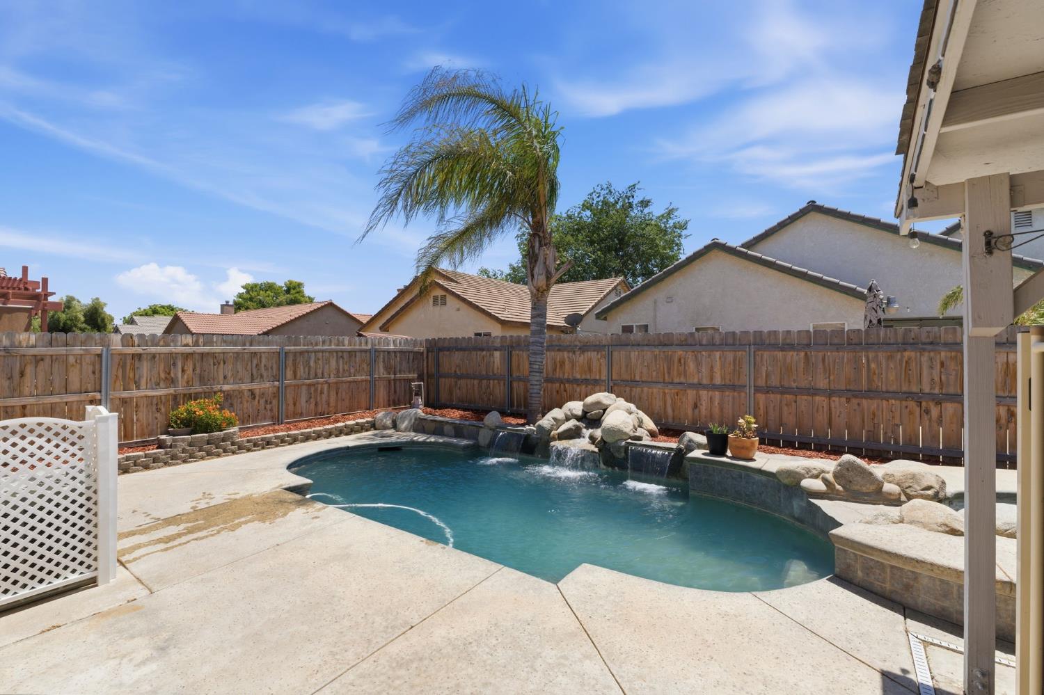 1757 Homestead Way Lemoore, CA 93245 - Photo 25 of 35 a view of a patio with table and chairs with wooden fence