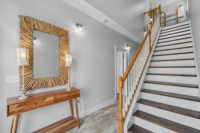 a view of staircase with wooden floor and a window