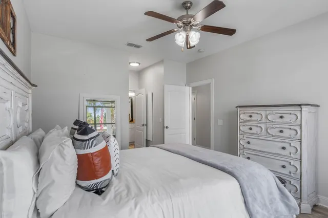 a bedroom with a bed and ceiling fan