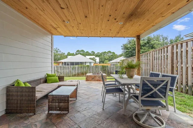 a view of a patio with table and chairs and potted plants