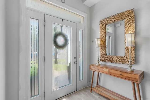 a view of a hallway with entryway wooden floor and front door