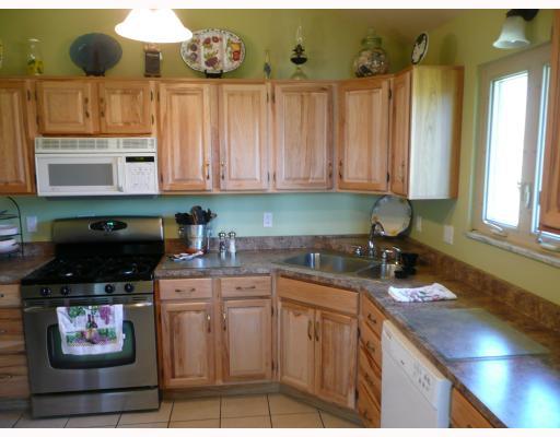 Kitchen. Beautiful Remodeled Kitchen with Hickory Cabinets, Stainless Gas Stove and Ceramic tiled Flooring. Lots Of Counter Space & Cabinets!