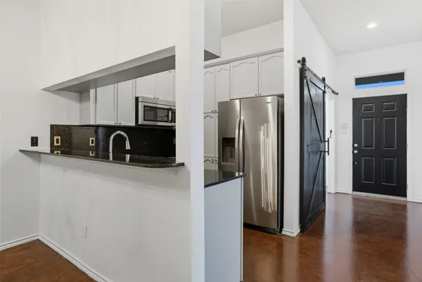 a kitchen with a stove and a refrigerator