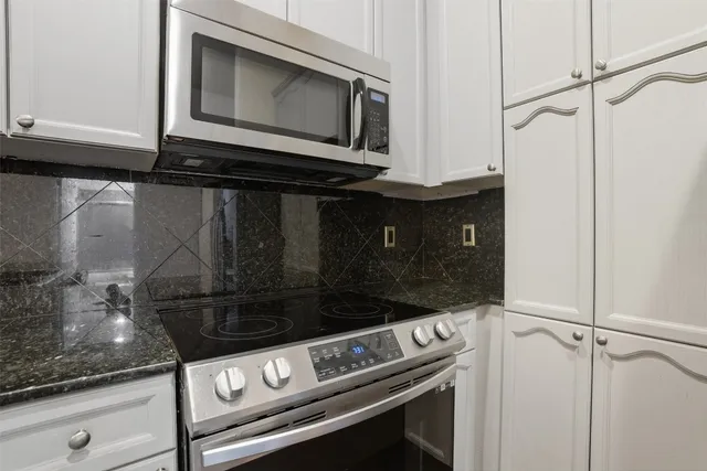 a kitchen with a stove top oven and refrigerator