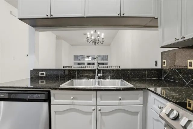 a kitchen with granite countertop cabinets stove and microwave