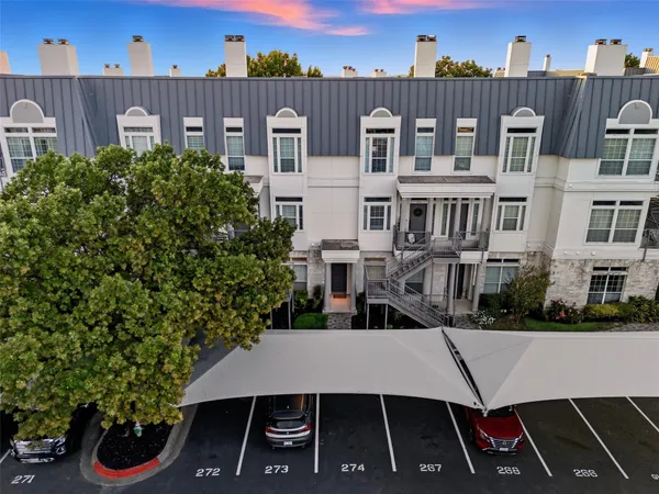 a view of a hallway with wooden floor and entryway