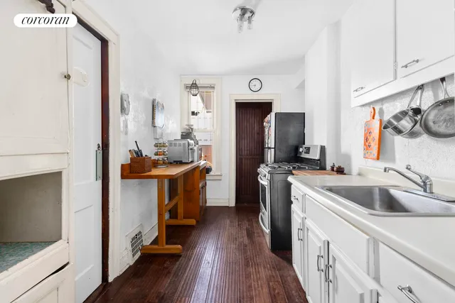 a kitchen with a sink cabinets and appliances