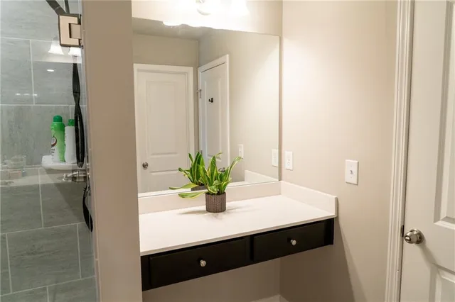 a room with a sink and mirror