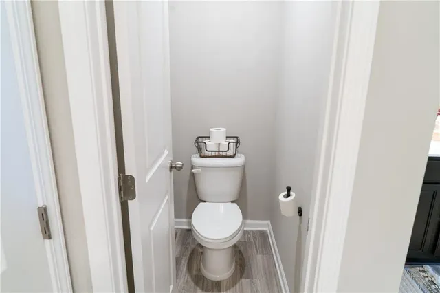 a white toilet sitting next to a shower