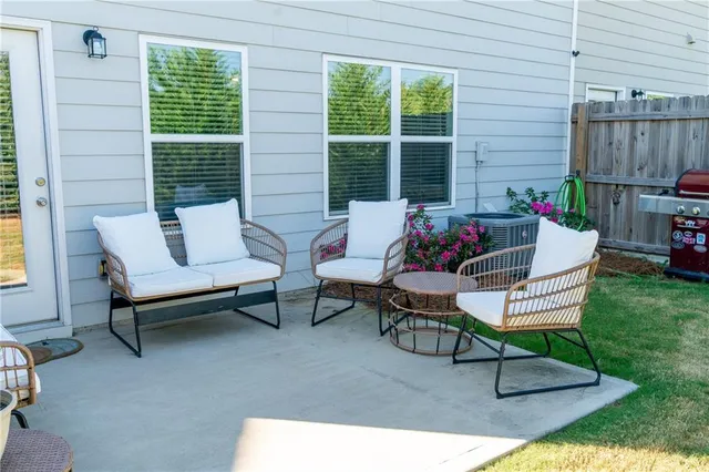a outdoor living space with furniture and a rug