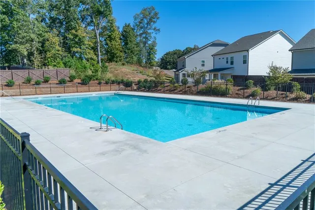 a view of a house with pool and sitting area