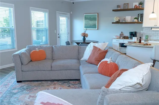 a living room with furniture and a potted plant