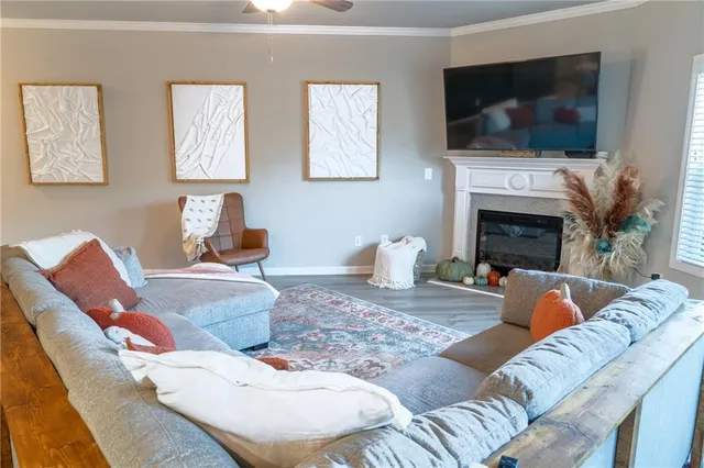 a living room with furniture a flat screen tv and a fireplace