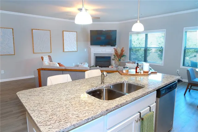 a kitchen with a sink a counter space and a fireplace