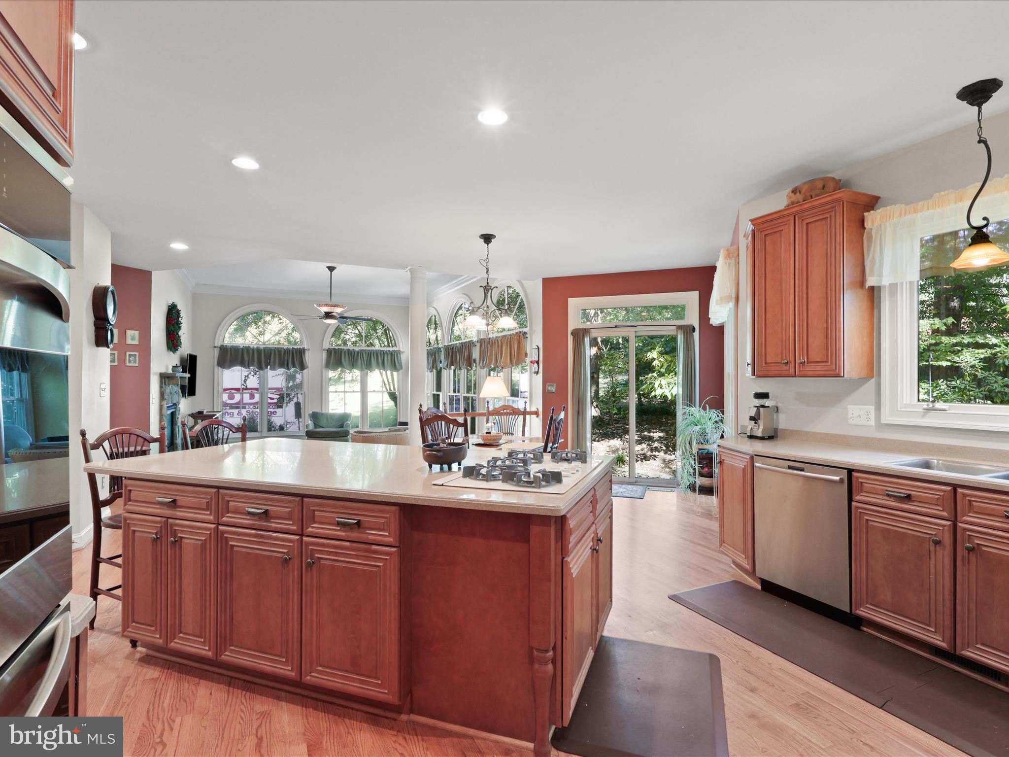 12848 Redbird Ridge Clifton, VA 20124 - Photo 12 of 76 a kitchen with granite countertop cabinets a sink and dishwasher a stove with wooden floor