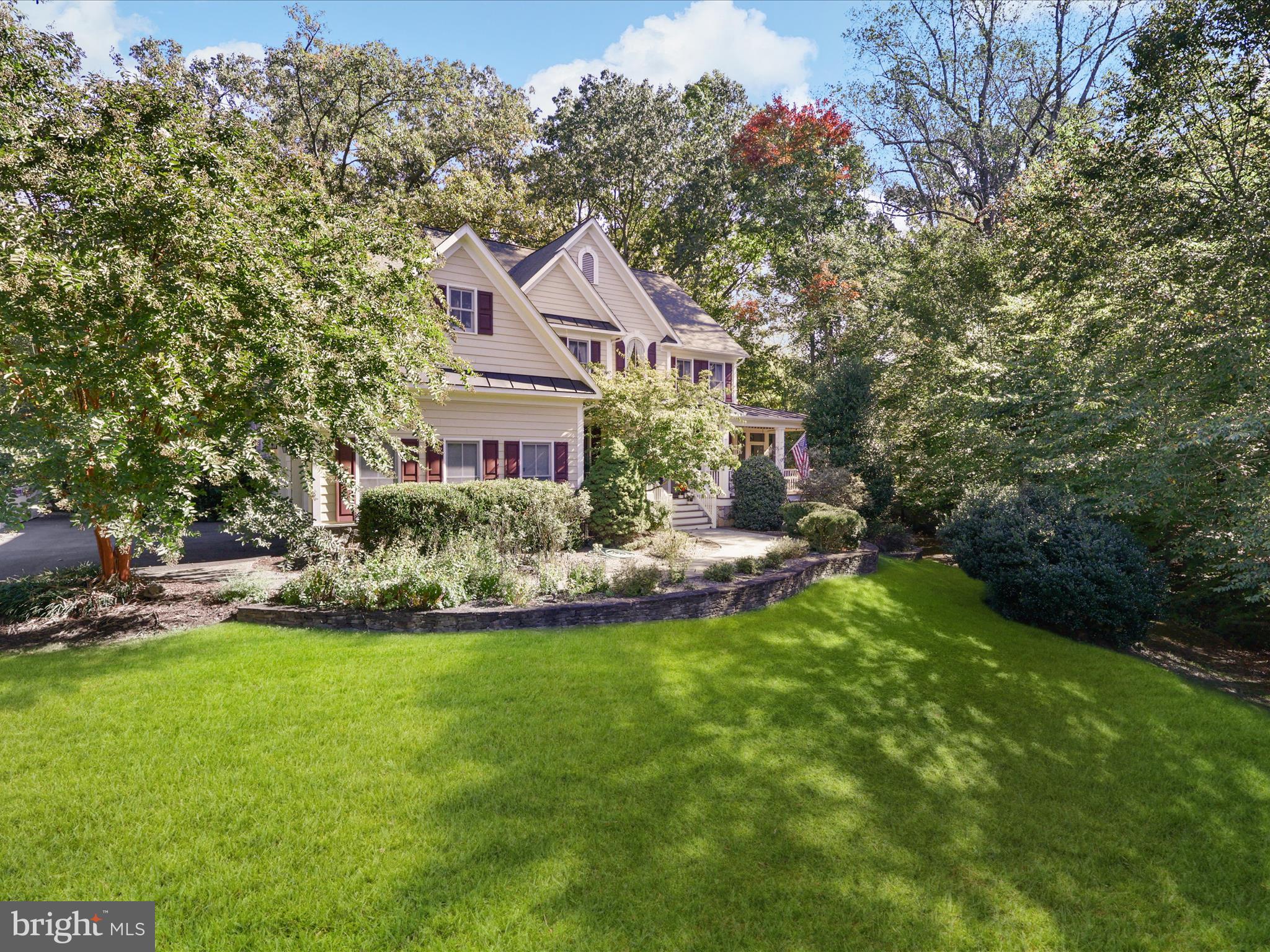 12848 Redbird Ridge Clifton, VA 20124 - Photo 2 of 76 a aerial view of a house with a yard table and chairs