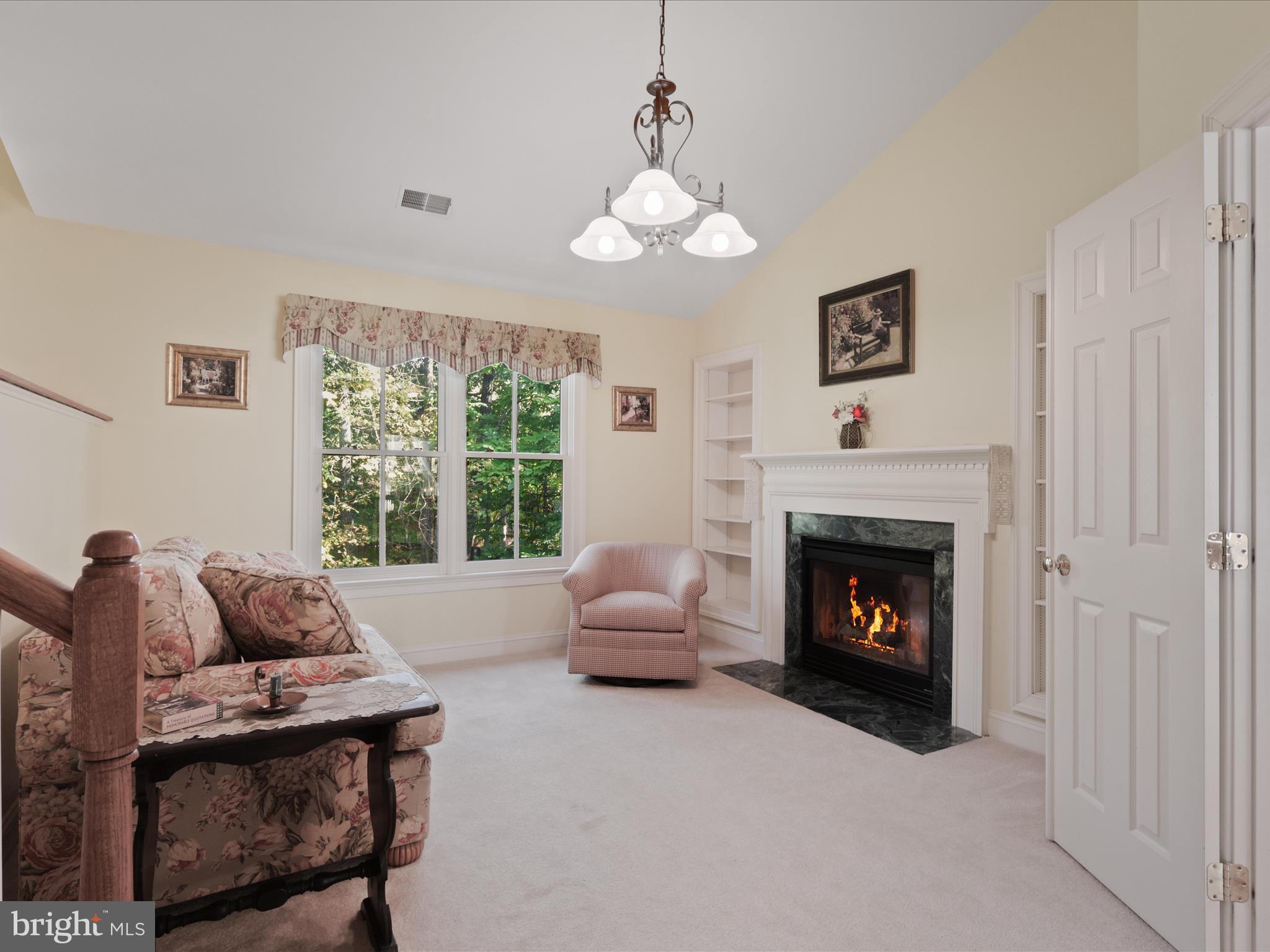 12848 Redbird Ridge Clifton, VA 20124 - Photo 31 of 76 a living room with furniture and a fireplace
