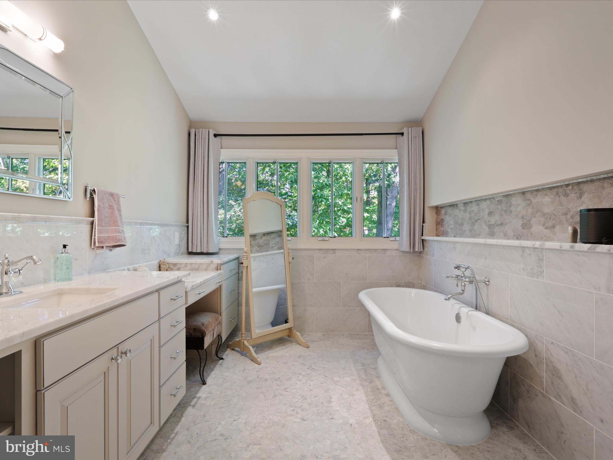 12848 Redbird Ridge Clifton, VA 20124 - Photo 33 of 76 a bathroom with a granite countertop sink and a bathtub