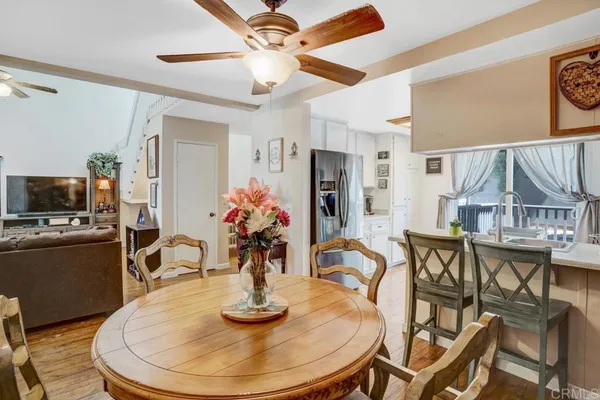 a dining room with furniture and wooden floor