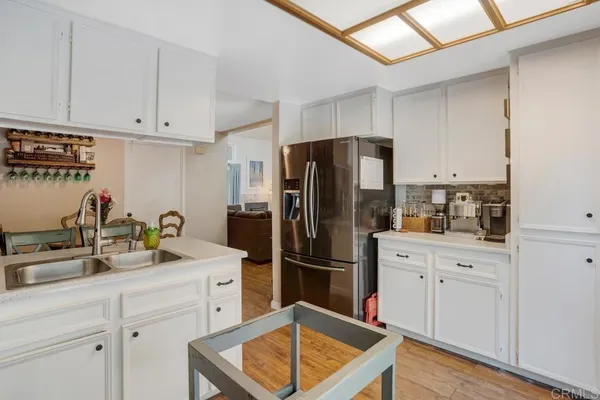 a kitchen with stainless steel appliances a refrigerator sink and cabinets