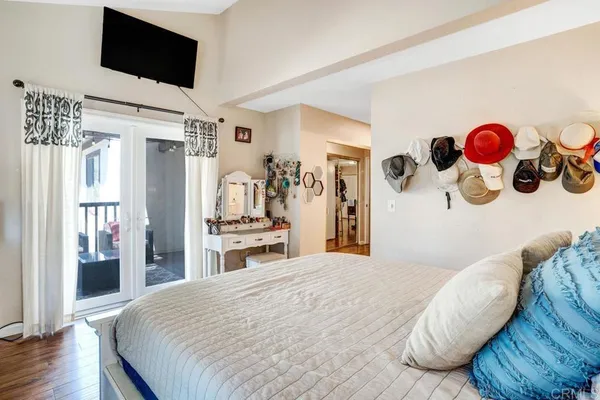 a bedroom with a bed and a flat screen tv