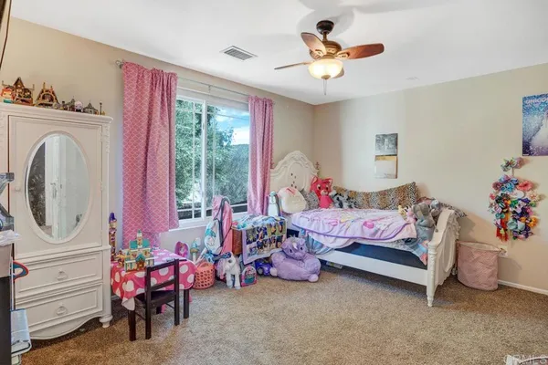 a bedroom with bed and a chandelier