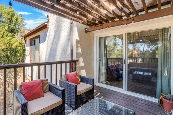 a balcony with furniture and wooden floor
