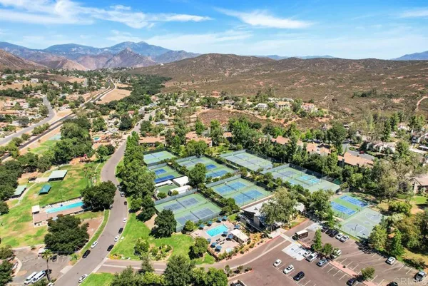 an aerial view of residential house with parking and mountain view