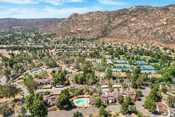 an aerial view of residential houses with city view