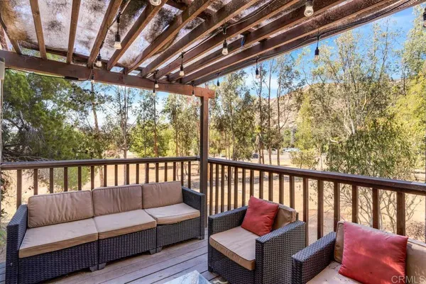 a roof deck with couch and wooden floor
