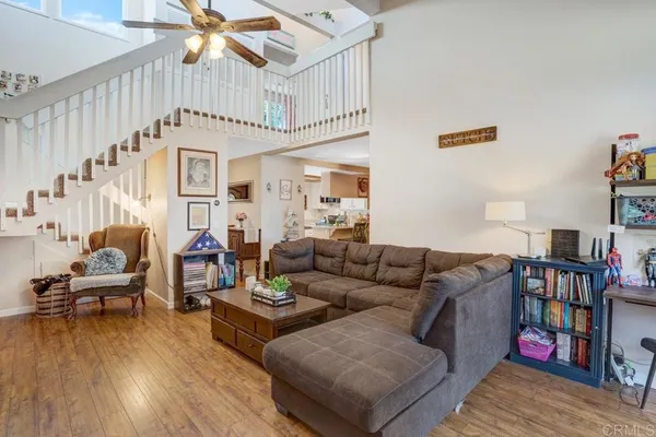 a living room with furniture and a book shelf