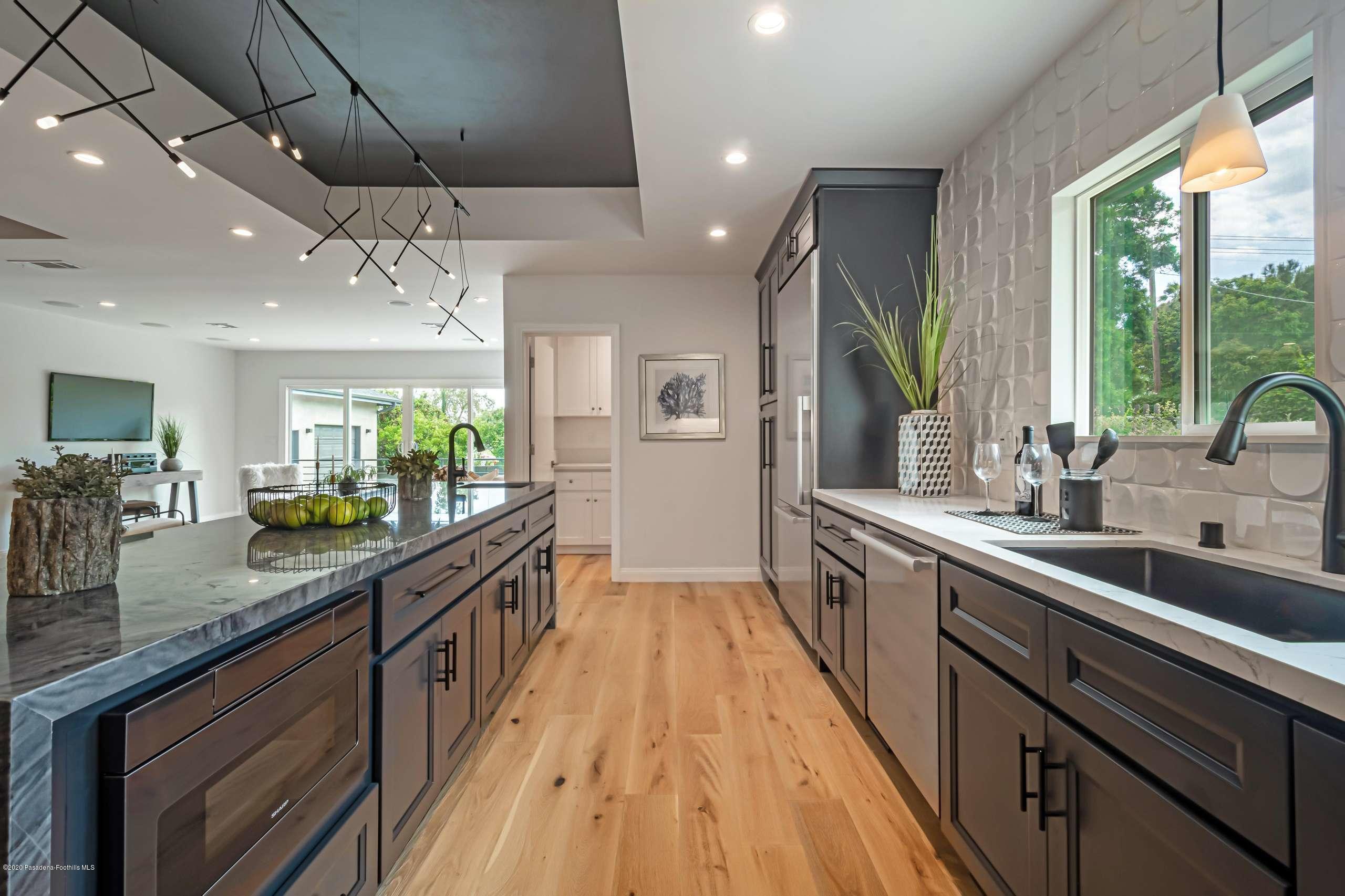 3590 Fairmeade Road Pasadena, CA 91107 - Photo 23 of 45 a large kitchen with stainless steel appliances a sink counter space cabinets and a large window