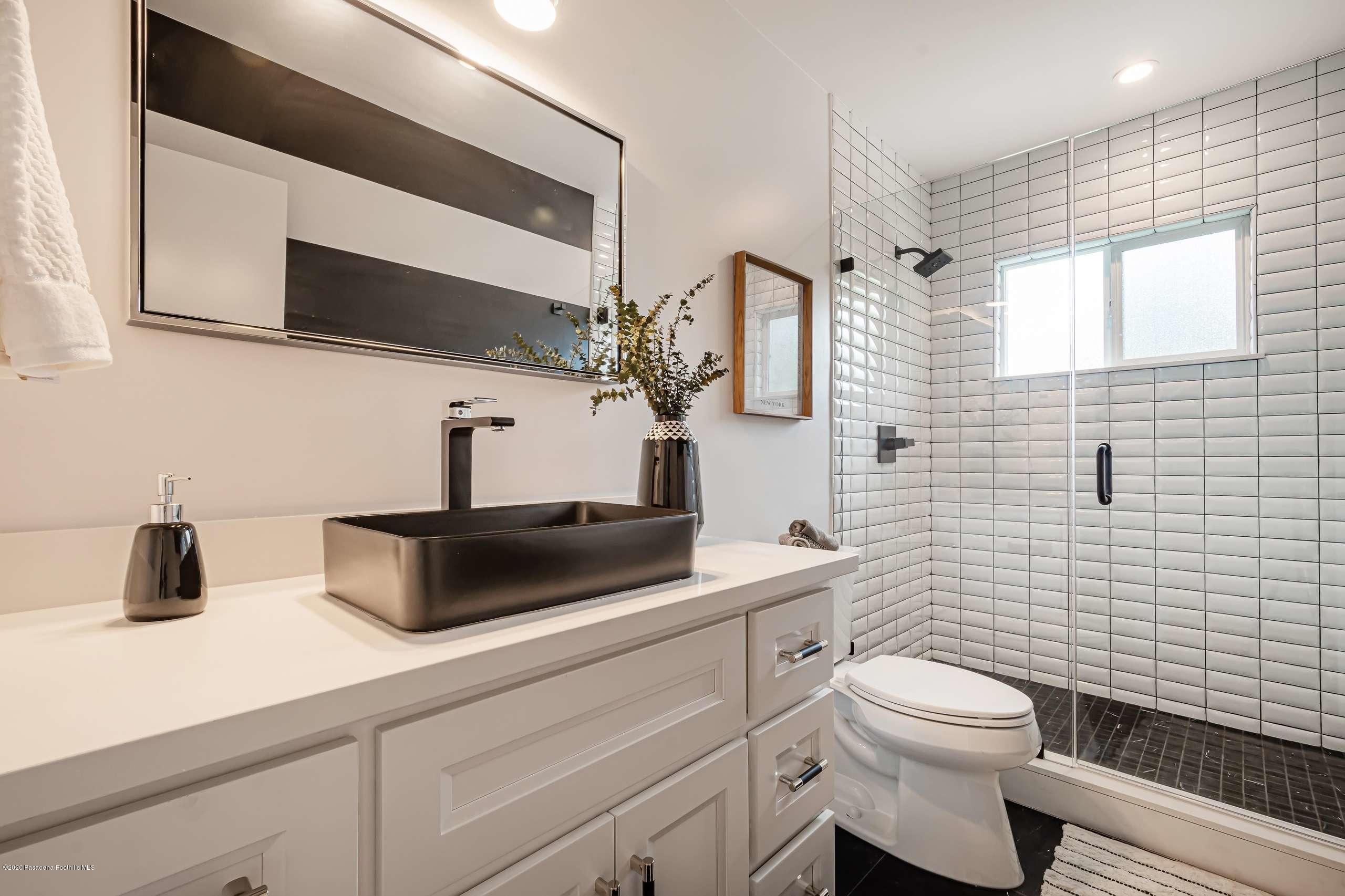 3590 Fairmeade Road Pasadena, CA 91107 - Photo 25 of 45 a bathroom with a toilet sink and mirror
