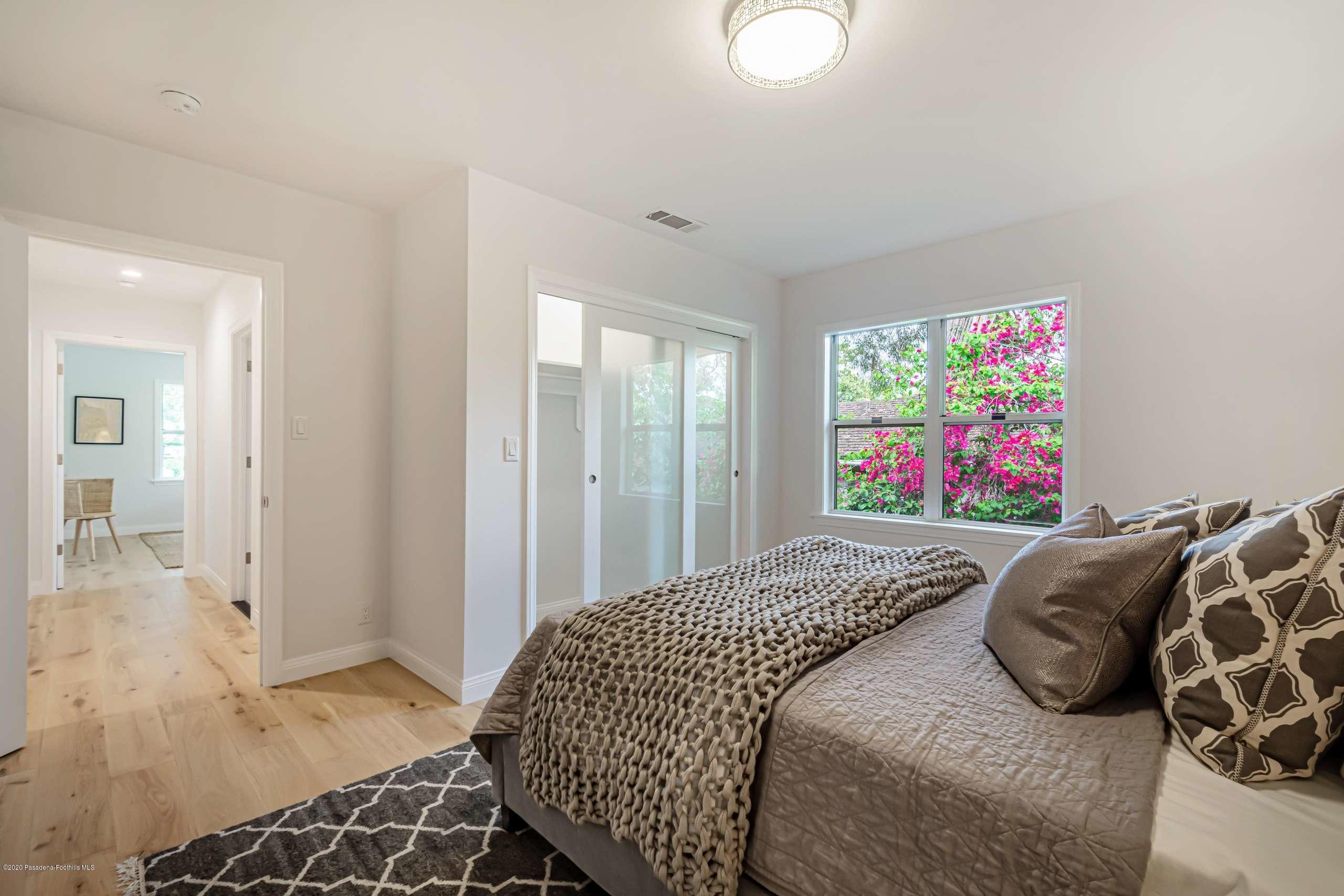 3590 Fairmeade Road Pasadena, CA 91107 - Photo 30 of 45 a bedroom with a bed and a painting on the wall