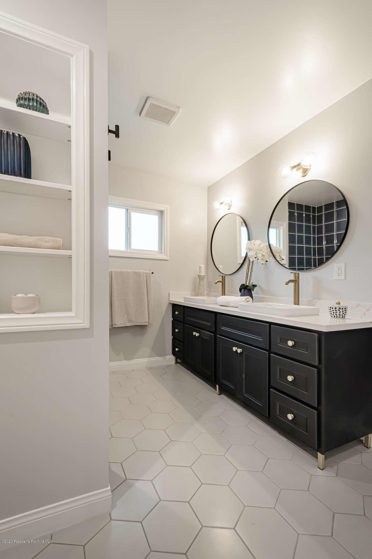 3590 Fairmeade Road Pasadena, CA 91107 - Photo 31 of 45 a bathroom with a double vanity sink and a mirror