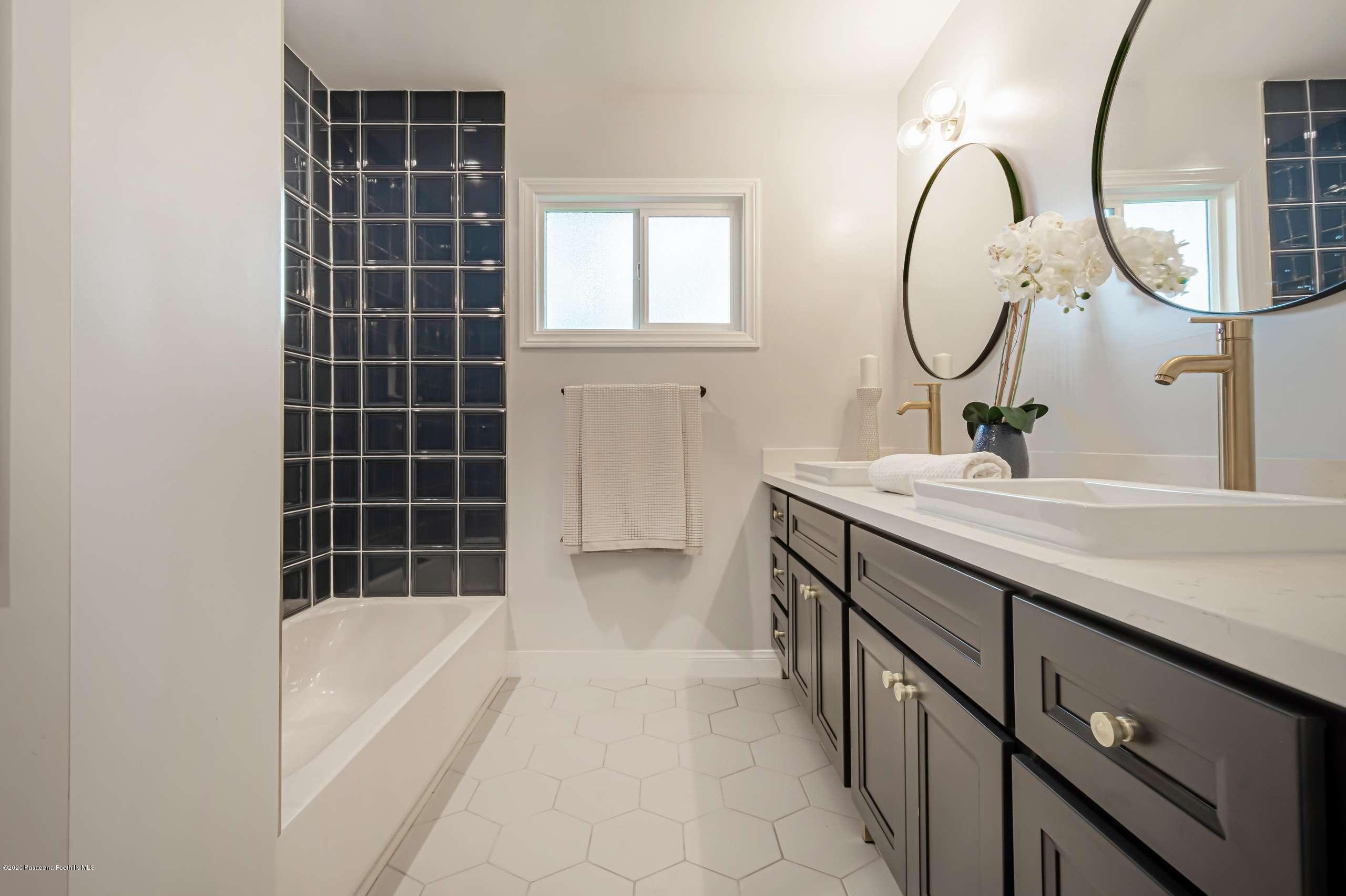 3590 Fairmeade Road Pasadena, CA 91107 - Photo 32 of 45 a bathroom with a double vanity sink and a mirror