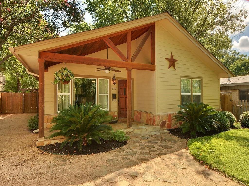 610 West N Loop Boulevard Austin, TX 78751 - Photo 1 of 29 The property features a charming exterior with light-colored siding and a stone facade