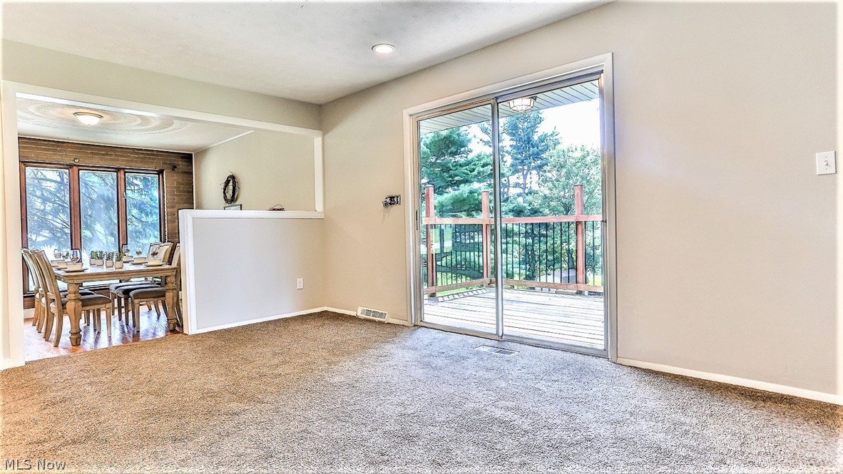 2116 Portage Line Road Mogadore, OH 44260 - Photo 11 of 35 *BONUS CARPETED AREA CAN BE USED AS SEATING AREA WITH COUCHES OR DINING WITH SLIDERS TO THE BACK DECK! ~
