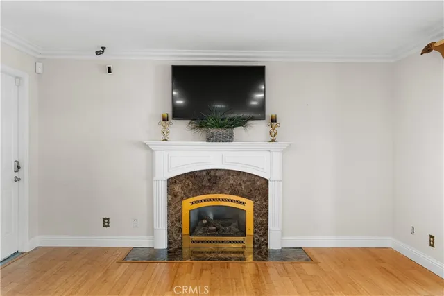 a living room with a fireplace and wooden floor